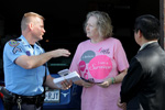 Senior Police Officer M.D. Prause and Councilmember Al Hoang offer safety tips to a Park Glen Resident