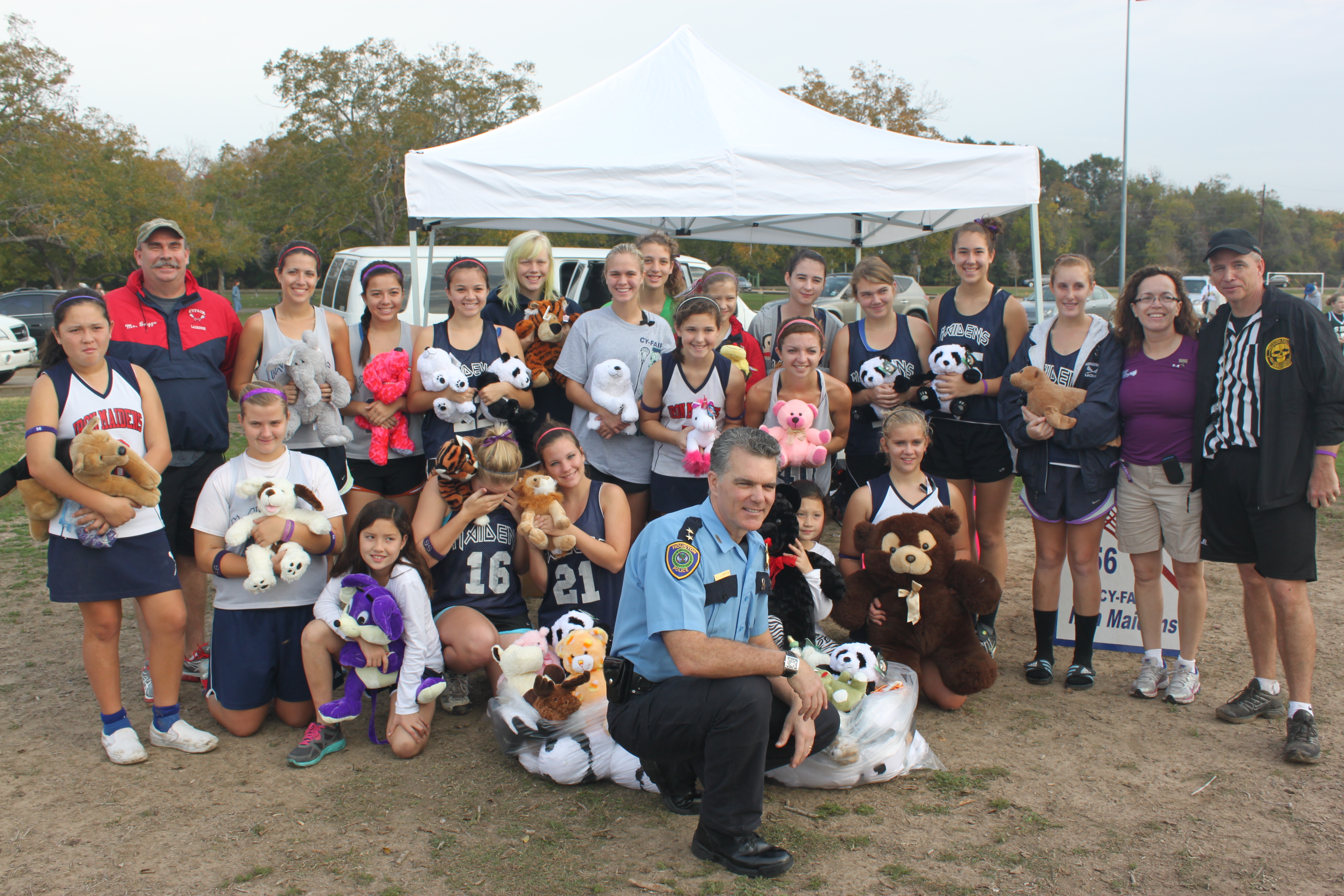 Julia's parents and former teammates with HPD Assistant Chief Brian Lumpkin (center) and HPD Sergeant Brian Harris (far right)